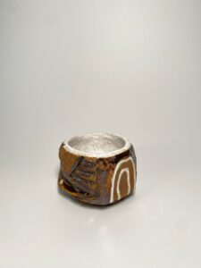 Hand holding sculptural teacup modern ceramics gift