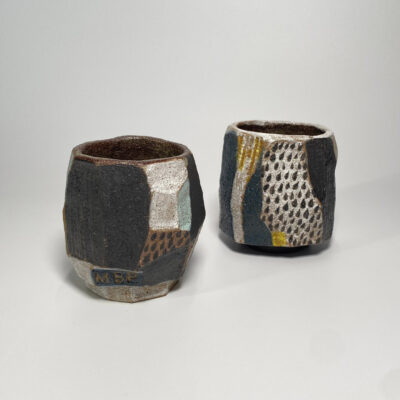 Abstract ceramic teacup geometric angles black glaze yellow speckles