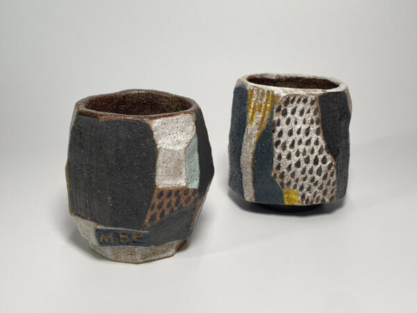Abstract ceramic teacup geometric angles black glaze yellow speckles