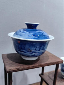 Close-up of hand-painted blue snowscape on porcelain tea bowl - Jingdezhen craftsmanship